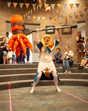 Atomicon-2024-costume contest with participant making a giant roar image