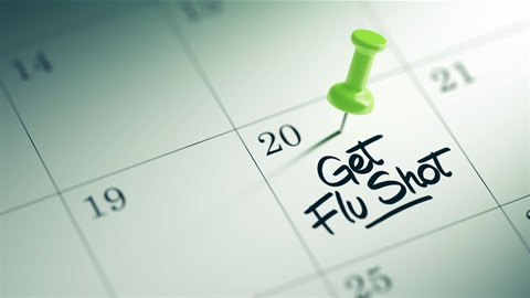 Stock photo of flu shot scheduled on a calendar