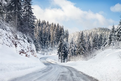 stock image showing a snowy mountain road
