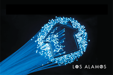 Black background with fiberoptic lights that form the shape of a home.
