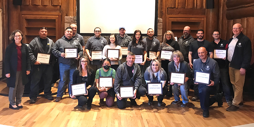 19 LAC Academy Graduates pose in Fuller Lodge holding certificates of completion on Nov. 16, 2023
