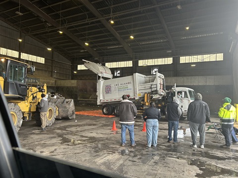 Collection Truck Radiation Investigation Image showing staff standing away from the truck as it is processed