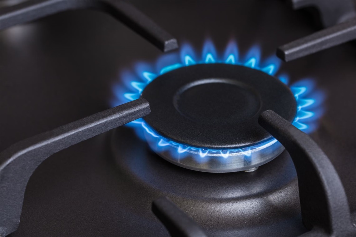 Blue natural gas flame on a gas stove burner Blue natural gas flame on a gas stove burner