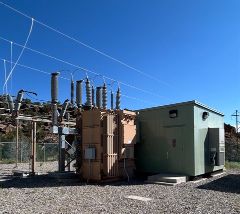 Photo of Transformer 1 at the White Rock Substation, a light green building on a gravel surface